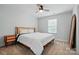 Well-lit bedroom featuring a cozy bed, wood furniture, neutral walls, and plush carpeting at 7322 Vesper Dr, Huntersville, NC 28078