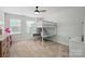 Bedroom with a bunk bed, desk and ample natural light from large windows at 7322 Vesper Dr, Huntersville, NC 28078