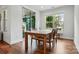 Sunlit dining room features a wooden table set near a window and sliding glass doors to the outdoor patio at 7322 Vesper Dr, Huntersville, NC 28078
