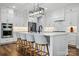 Beautiful kitchen features a large central island with seating, pendant lighting, and stainless steel appliances at 7322 Vesper Dr, Huntersville, NC 28078