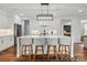 Bright kitchen features white cabinets, stainless appliances, a large island with seating, and stylish lighting at 7322 Vesper Dr, Huntersville, NC 28078