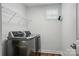 Functional laundry room with modern washer and dryer, shelving, and natural light at 7322 Vesper Dr, Huntersville, NC 28078