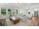Open-concept living room with hardwood floors, natural light, and access to the kitchen at 7322 Vesper Dr, Huntersville, NC 28078