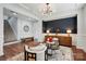Inviting living room with a dark accent wall, modern furniture, decorative lighting, and an open entryway at 7322 Vesper Dr, Huntersville, NC 28078