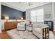 Stylish living room features a dark accent wall, modern lighting, neutral armchairs, and sophisticated decor at 7322 Vesper Dr, Huntersville, NC 28078