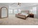 Serene main bedroom with tray ceiling, plush carpet, and ample natural light at 7322 Vesper Dr, Huntersville, NC 28078