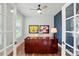 Home office with a striking blue accent wall, rich wood desk, natural light, and sports memorabilia decor at 7322 Vesper Dr, Huntersville, NC 28078