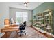 Bright home office with a contemporary desk, sleek chair, and decorative shelving against a calming green wall at 7322 Vesper Dr, Huntersville, NC 28078
