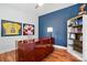 A home office displays a bold accent wall, sports memorabilia and a stylish desk, creating a productive and personalized space at 7322 Vesper Dr, Huntersville, NC 28078