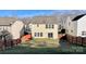 Backyard with grass and wood fence, view of the back exterior of the home at 8139 Deodora Cedar Ln, Charlotte, NC 28215