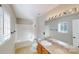 Well-lit bathroom with a tub-shower combo and a large mirror above the vanity at 8139 Deodora Cedar Ln, Charlotte, NC 28215