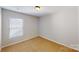 Cozy bedroom with neutral carpeting, a window and a ceiling light fixture at 8139 Deodora Cedar Ln, Charlotte, NC 28215