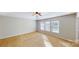 Spacious carpeted bedroom with a ceiling fan and bright natural light from three windows at 8139 Deodora Cedar Ln, Charlotte, NC 28215