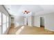 Large bedroom with a tray ceiling, neutral walls and carpeted floors and two entry doors at 8139 Deodora Cedar Ln, Charlotte, NC 28215