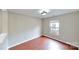 Cozy bedroom with a large window allowing plenty of natural light, neutral walls, and hardwood floors at 8139 Deodora Cedar Ln, Charlotte, NC 28215
