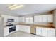 Bright kitchen with stainless steel appliances, white cabinets, and tile flooring at 8139 Deodora Cedar Ln, Charlotte, NC 28215