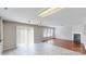 Bright living room with a cozy fireplace, sliding glass doors, and sleek tile flooring at 8139 Deodora Cedar Ln, Charlotte, NC 28215