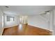 Bright living room with hardwood floors, neutral decor, and an open layout to the adjoining rooms at 8139 Deodora Cedar Ln, Charlotte, NC 28215