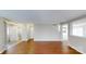 Open living space with hardwood floors, neutral walls, and a view of the stairway leading upstairs at 8139 Deodora Cedar Ln, Charlotte, NC 28215