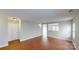 Spacious living room with hardwood floors, neutral color scheme, and an open layout flowing into other areas at 8139 Deodora Cedar Ln, Charlotte, NC 28215