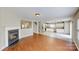 An open-concept view into the kitchen and stairs from the living room, complete with a fireplace at 8139 Deodora Cedar Ln, Charlotte, NC 28215
