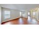 Sunlit living room boasting hardwood floors, neutral walls, and ample windows for abundant natural light at 8139 Deodora Cedar Ln, Charlotte, NC 28215
