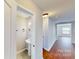 Cozy powder room featuring a pedestal sink, tiled floor, and modern light fixture at 8139 Deodora Cedar Ln, Charlotte, NC 28215