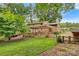 Charming backyard featuring a wooden deck, covered area, and a lush green lawn at 841 12Th Nw Ave, Hickory, NC 28601