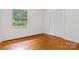 This bedroom features hardwood floors, a window with a view, and a closet at 841 12Th Nw Ave, Hickory, NC 28601