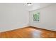 This bedroom boasts hardwood floors, a window, and natural light at 841 12Th Nw Ave, Hickory, NC 28601