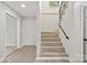 Inviting entryway with carpeted stairs, wood-style flooring, and a white front door at 841 12Th Nw Ave, Hickory, NC 28601