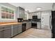 Modern kitchen with sleek black appliances, gray cabinets, and butcher block countertops at 841 12Th Nw Ave, Hickory, NC 28601