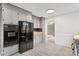 Well-lit kitchen with grey cabinets, stainless steel appliances, and wood-look vinyl flooring at 841 12Th Nw Ave, Hickory, NC 28601