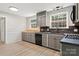 Updated kitchen boasts gray cabinets, black appliances, and modern laminate floors at 841 12Th Nw Ave, Hickory, NC 28601