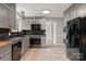 Well-lit kitchen featuring gray cabinets, modern appliances, and updated laminate flooring at 841 12Th Nw Ave, Hickory, NC 28601
