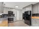 Kitchen featuring modern appliances, ample cabinet space, and durable laminate flooring at 841 12Th Nw Ave, Hickory, NC 28601