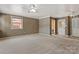 Large living room with ceiling fan, carpet, and multiple windows for ample natural light at 841 12Th Nw Ave, Hickory, NC 28601