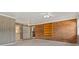 Open living room with a brick wall, wood-style flooring, and built in shelves at 841 12Th Nw Ave, Hickory, NC 28601
