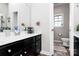Bathroom with double vanity, tiled floor and open doorway to separate toilet area at 9011 Kensington Forest Dr, Harrisburg, NC 28075