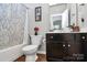 Cozy bathroom with vanity, mirror, and shower tub combination with patterned shower curtain at 9011 Kensington Forest Dr, Harrisburg, NC 28075