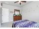 Comfortable bedroom featuring plush carpet, a ceiling fan, and a classic wooden dresser with mirror at 9011 Kensington Forest Dr, Harrisburg, NC 28075