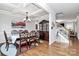Elegant dining room with coffered ceilings, hardwood floors, and a staircase at 9011 Kensington Forest Dr, Harrisburg, NC 28075