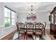 Bright dining room featuring trey ceilings, hardwood floors, and stylish furnishings at 9011 Kensington Forest Dr, Harrisburg, NC 28075