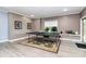 A game room offers space for entertainment with table tennis and a wall of windows for natural light at 9011 Kensington Forest Dr, Harrisburg, NC 28075