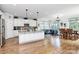 Open kitchen features a large island, stainless steel appliances, and eat-in dining area at 9011 Kensington Forest Dr, Harrisburg, NC 28075