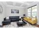Stylish living room with tray ceiling, modern decor, and ample natural light at 9011 Kensington Forest Dr, Harrisburg, NC 28075