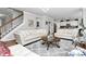 Open-concept living room with staircase, hardwood floors, and modern decor at 9011 Kensington Forest Dr, Harrisburg, NC 28075