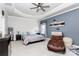 Spacious bedroom featuring a tray ceiling, a ceiling fan, and a decorative sitting chair at 9011 Kensington Forest Dr, Harrisburg, NC 28075
