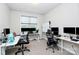 Bright home office with multiple workstations, natural light, and neutral decor at 9011 Kensington Forest Dr, Harrisburg, NC 28075