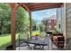 An outdoor patio offers a relaxing space for outdoor dining and entertainment with a view of the backyard at 9011 Kensington Forest Dr, Harrisburg, NC 28075